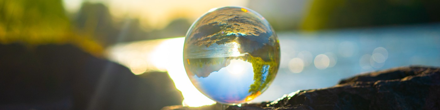 Crystal ball reflecting a river landscape